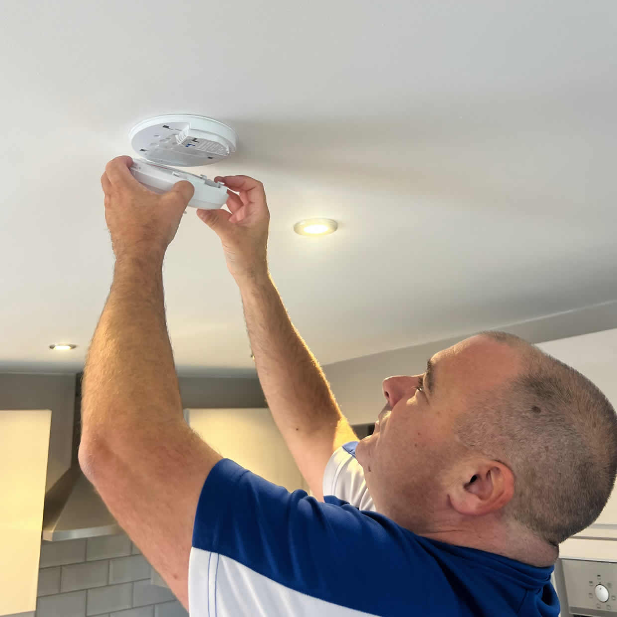 Smoke alarm being installed on a ceiling in Yate